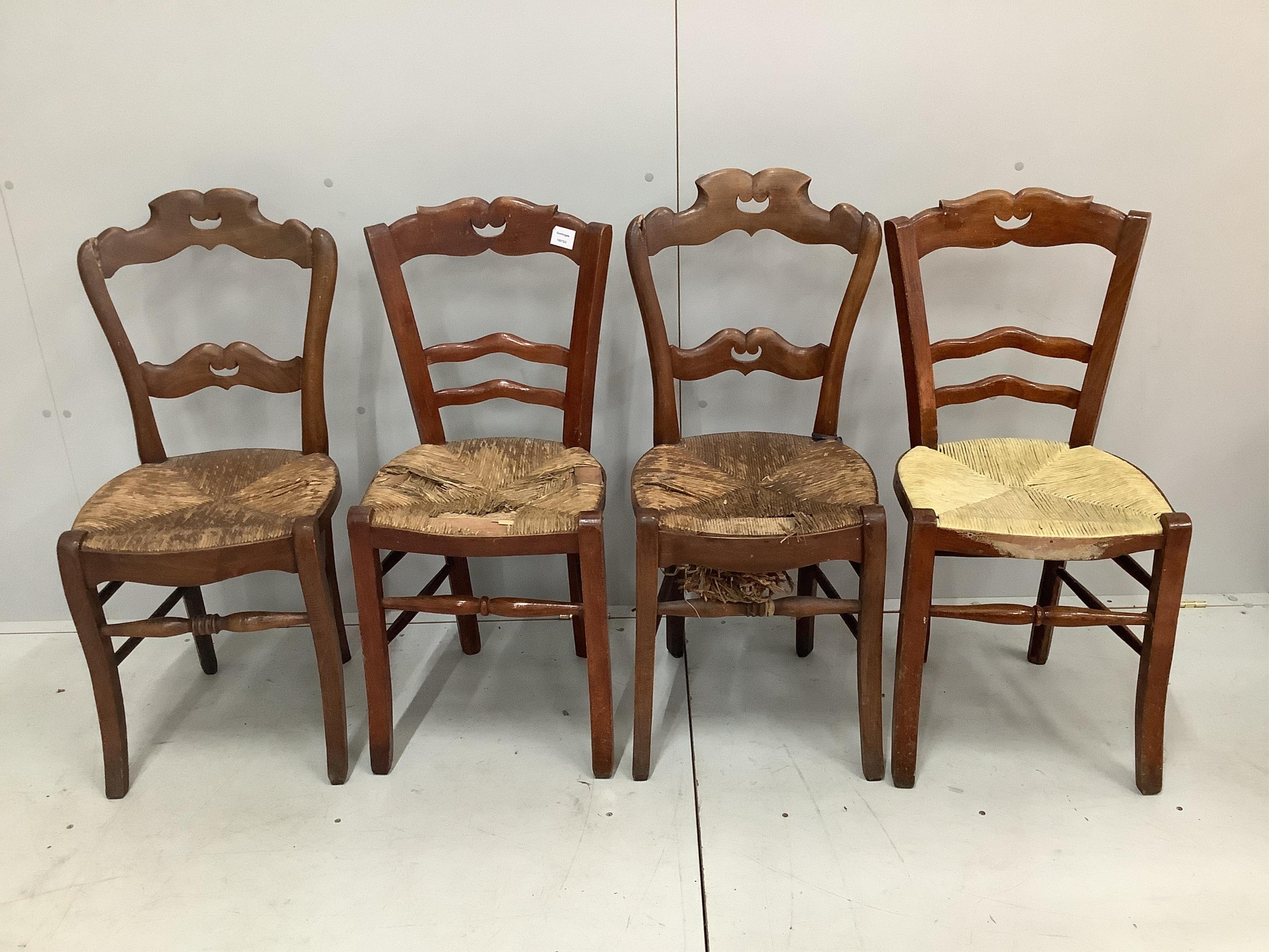 A set of four 19th century French provincial rush seat dining chairs, height 90cm. Condition - poor to fair